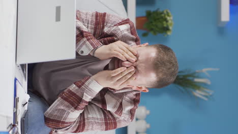 Vertical-video-of-Home-office-worker-man-has-eye-pain.